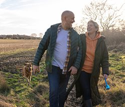 couple-enjoying-life-dog-field.jpg