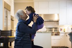 Grandmother-lifting-up-two-year-old-and-touching-noses.jpg